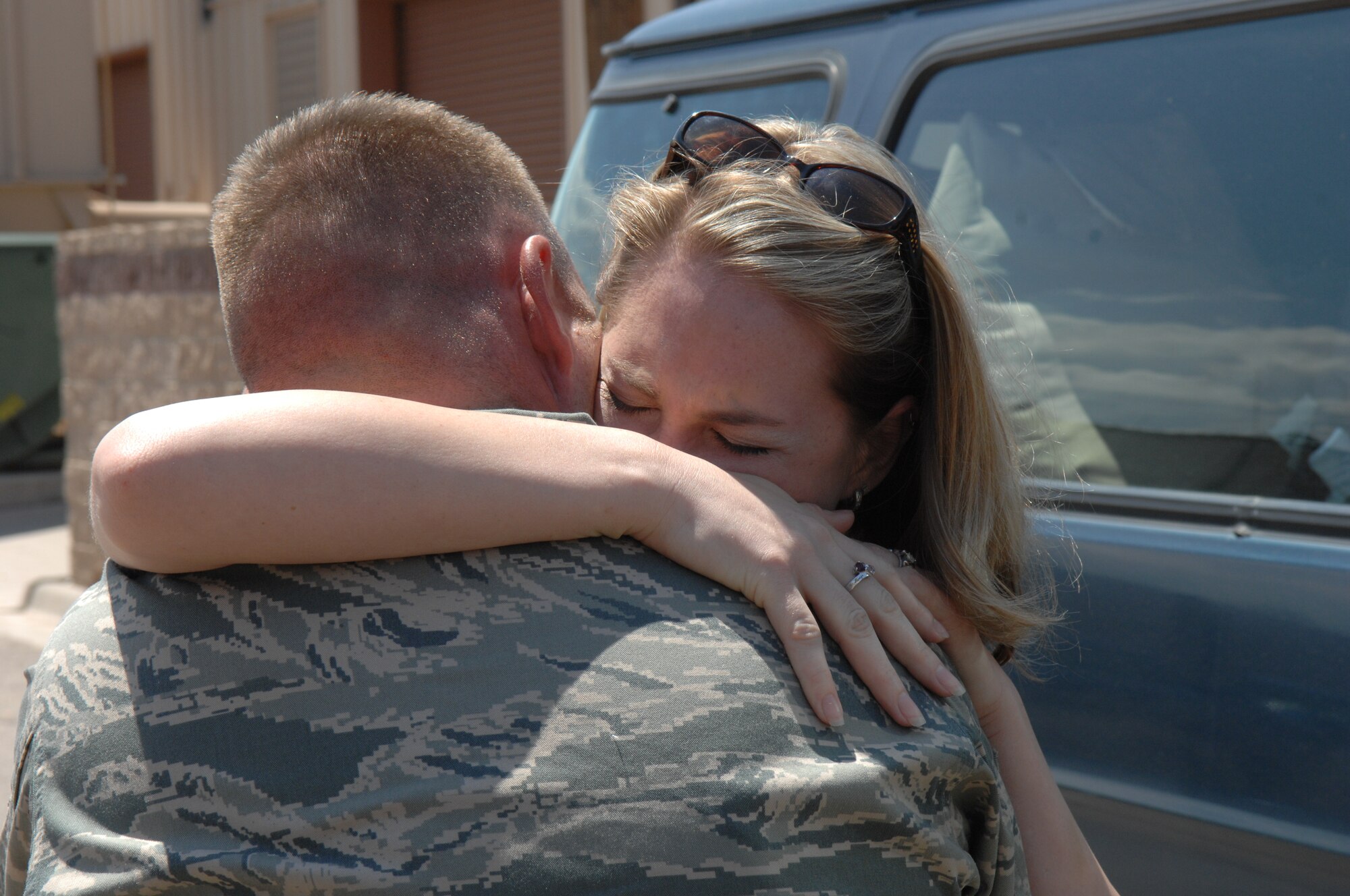 Tech. Sgt. Shaun Goodenow, 49th Civil Engineer Squadron, is greeted by his wife Aug. 6 at Holloman Air Force Base, N.M., after returning home from a four month deployment. Sergeant Goodenow was deployed with three other Airmen from the 49th CES. While deployed, the team moved 700,000 feet of rubber to six locations in three different countries to include Iraq and Afghanistan. (U.S. Air Force photo/Senior Airman Anthony Nelson Jr)