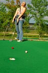 MINOT, N.D. -- Airman 1st Class Natasha Ashley, 742nd Missile Squadron, missile alert facility chef, reacts as her golf ball misses the hole by inches Aug. 9 at Valleyview Falls Mini-Golf-Go. Every weekend a group of Warbirds and Rough Riders find activities in and around Minot to keep themselves entertained. (U.S. Air Force photo by Airman 1st Class Benjamin Stratton)