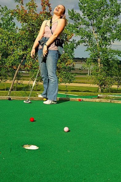 MINOT, N.D. -- Airman 1st Class Natasha Ashley, 742nd Missile Squadron, missile alert facility chef, reacts as her golf ball misses the hole by inches Aug. 9 at Valleyview Falls Mini-Golf-Go. Every weekend a group of Warbirds and Rough Riders find activities in and around Minot to keep themselves entertained. (U.S. Air Force photo by Airman 1st Class Benjamin Stratton)