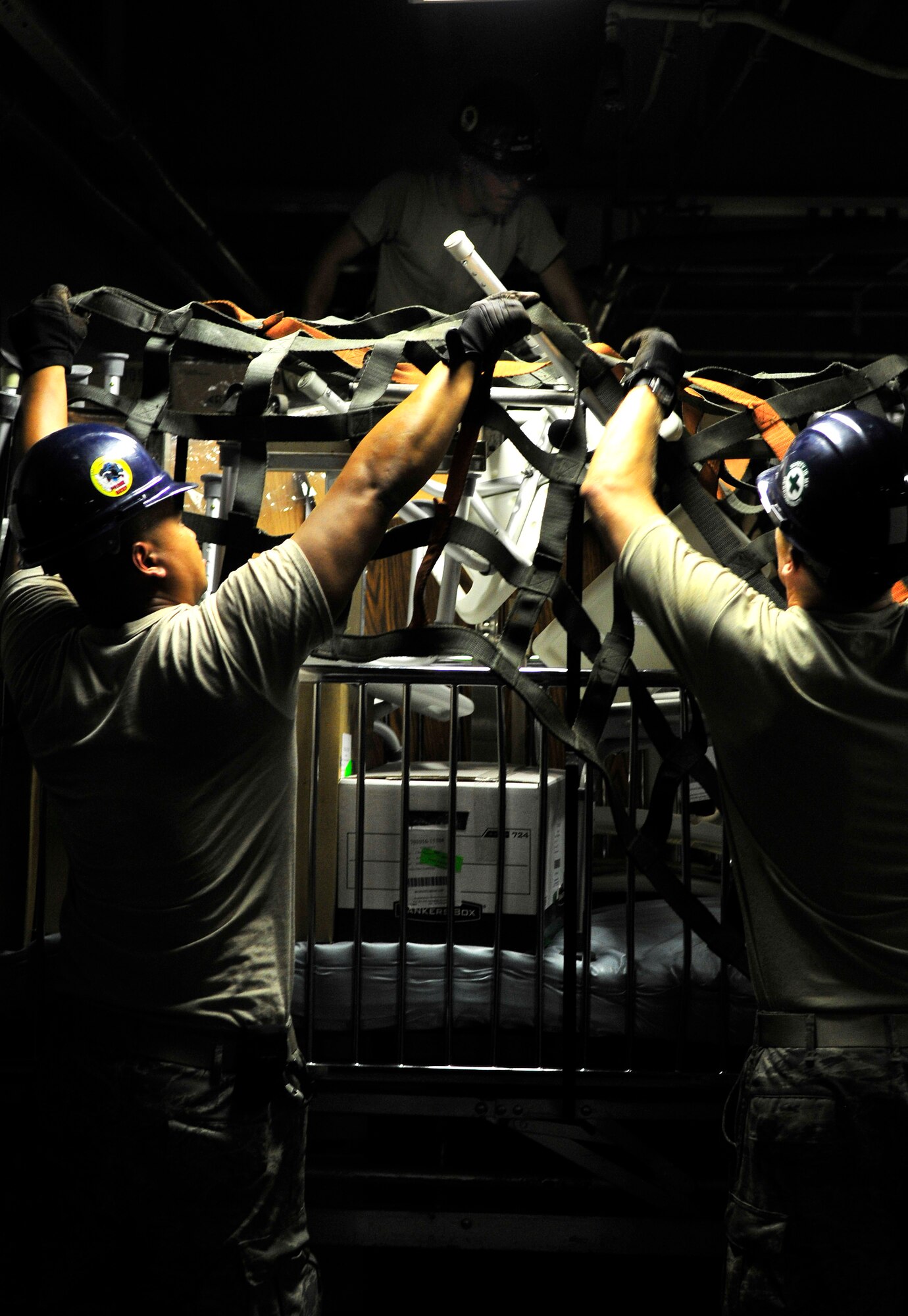 ABOARD USS KEARSARGE (LHD 3) -- Staff Sgt.Tang Hy, Airman 1st Class Geoff Hamilton and Staff Sgt. Chad Gerrits, all from the 5th Civil Engineer Squadron Prime Base Engineer Emergency Force, secure cargo in the lower vehicle hold aboard the USS Kearsarge (LHD 3) Aug. 5. The Airmen are deployed in support of Continuing Promise 2008, (CP08), an equal-partnership mission between the United States, Canada, the Netherlands, Brazil, Nicaragua, Panama, Colombia, Dominican Republic, Trinidad and Tobago and Guyana. (U.S. Navy photo by Mass Communication Specialist Seaman Apprentice Joshua Adam Nuzzo)