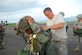 SOTO CANO AIR BASE, Honduras -- Army Staff Sgt. David Hattan, Joint Task Force-Bravo Rigger NCOIC, looks over the parachute of a Honduran Air Force servicemember Aug. 8. Sergeant Hattan is one of only two Army riggers stationed here. (U.S. Air Force photo by Staff Sgt. Joel Mease)