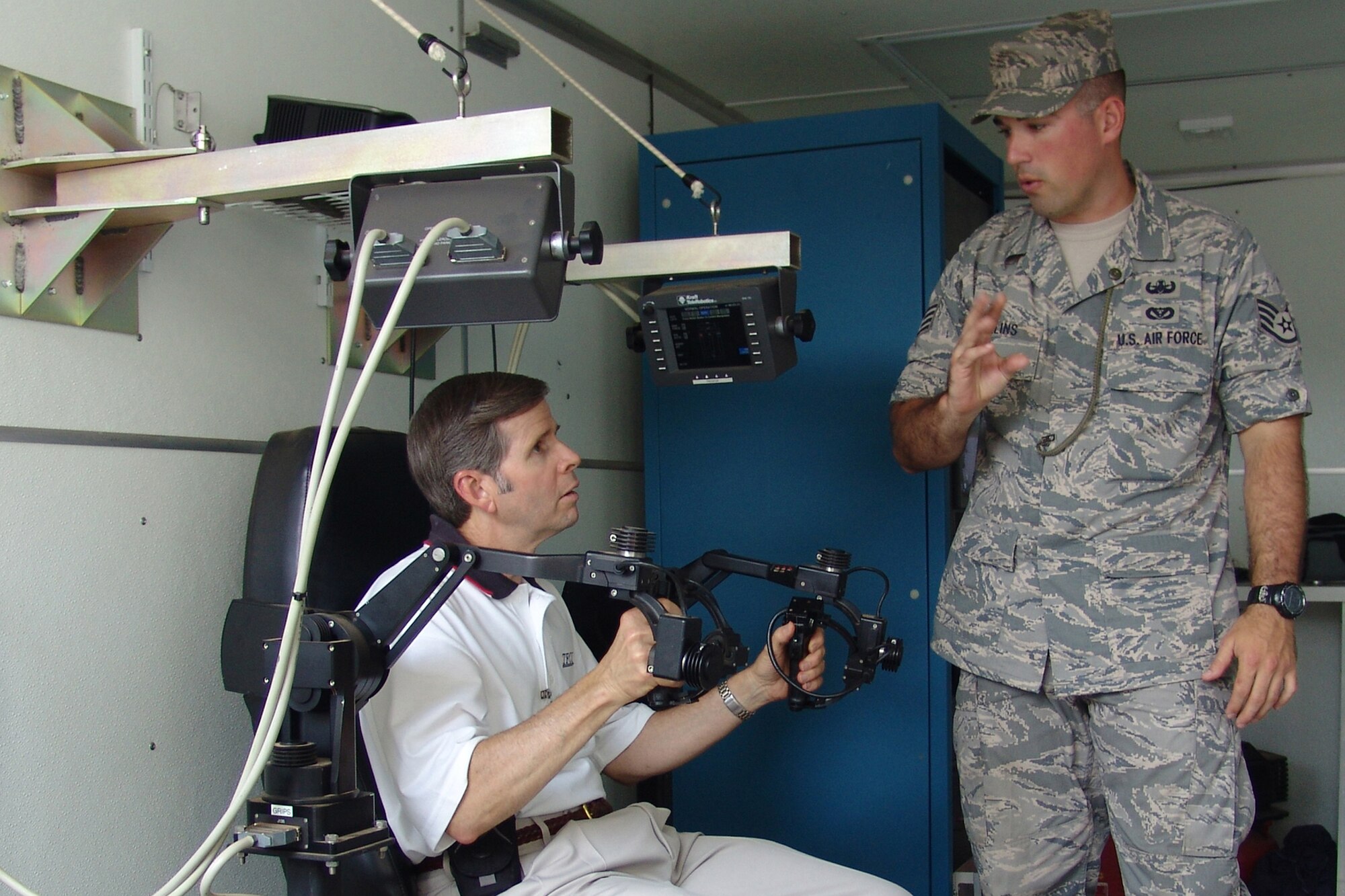 Tinker AFB civic leader Michael Klobber listens to Staff Sgt. John Collins explain the controls of an EOD robot.  Twenty-seven members of the Tinker AFB Community Star programwere at Eglin Aug. 8 to learn about the missions here. (USAF photo by Chrissy Cuttita)