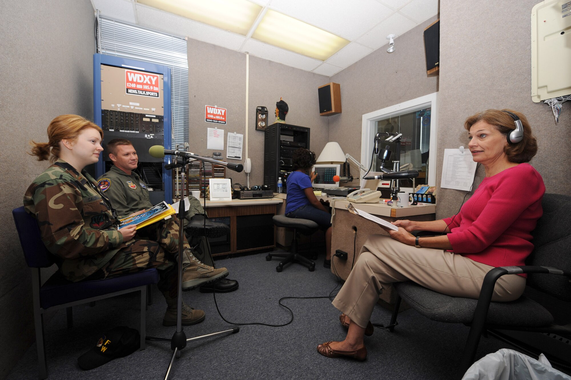 SHAW AIR FORCE BASE, S.C.-- Susan Trautsch (right) from Miller Communications speaks with Lt. Col. Jay Wilkerson, 20th Fighter Wing chief of safety, and 2nd Lt. Noelle Caldwell, 20th Fighter Wing Public Affairs, on WDXY 1240 am 105.9 fm, a local radio station, Aug. 8. Lt. Col. Wilkerson talks about special needs day and Shaw Fest 2008 thunder over midlands and how it will be here Sept. 6. The purpose behind the radio interview is to keep the public informed of ongoing events at Shaw. (U.S. Air Force photo/Staff Sgt Henry Hoegen)