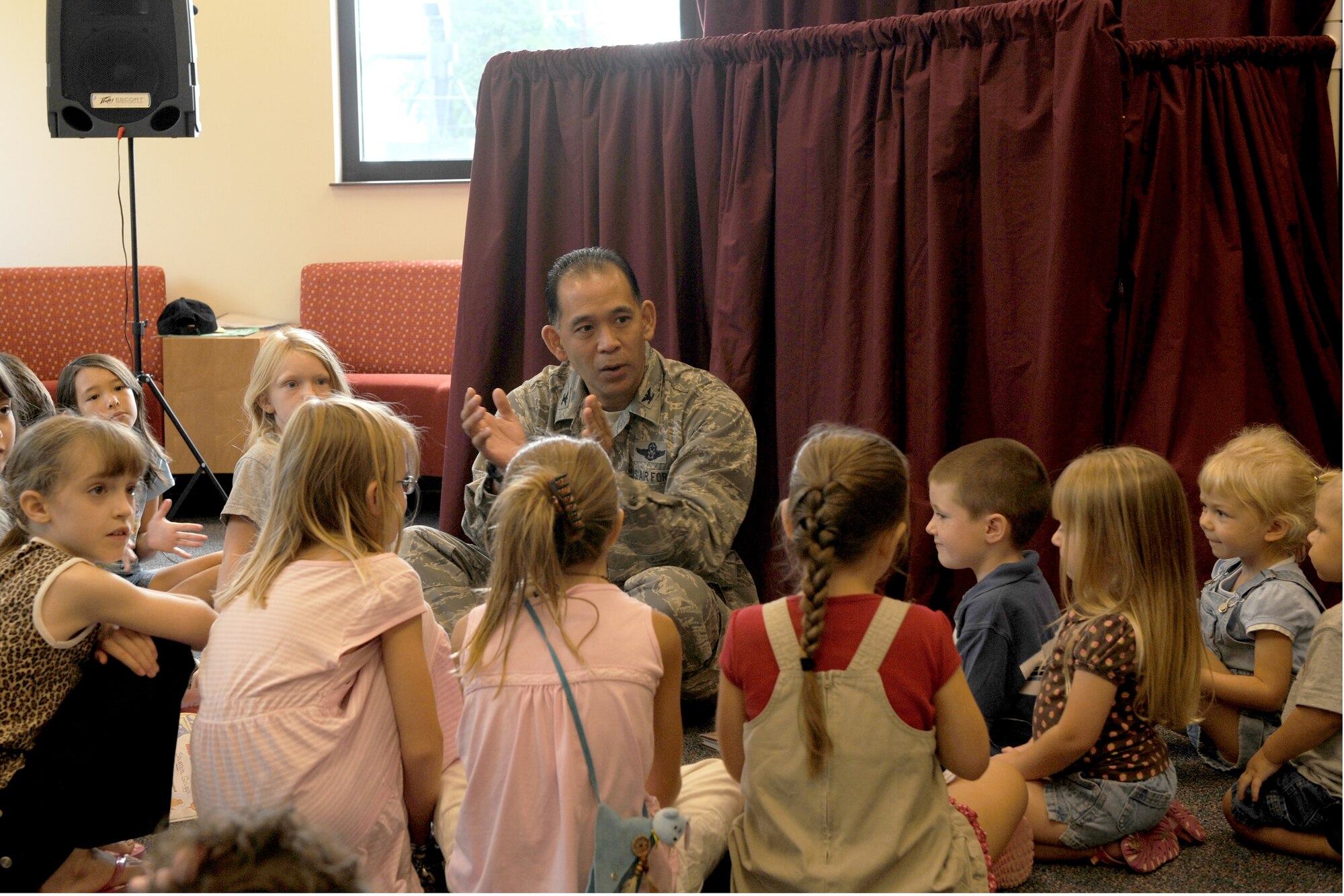 SHAW AIR FORCE BASE, S.C. -- Col. Ted Uchida, 20th Mission Support Group commander, talks with children about the importance of reading as part of culmination of the summer reading program sponsored by the base library August 8. The group of military dependents amassed a combined total of more than 500 reading hours during the program. (U.S. Air Force photo/Staff Sgt. Henry Hoegen)
