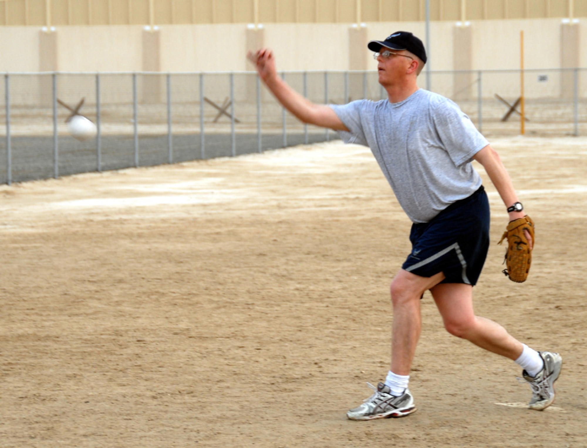 SOUTHWEST ASIA -- Over 40 pitcher, Tim MacGregor, applies finesse as he strives for the six- to 12-foot arc required in slow-pitch softball. (U.S. Air Force photo/Tech. Sgt. Denise Johnson)(released)