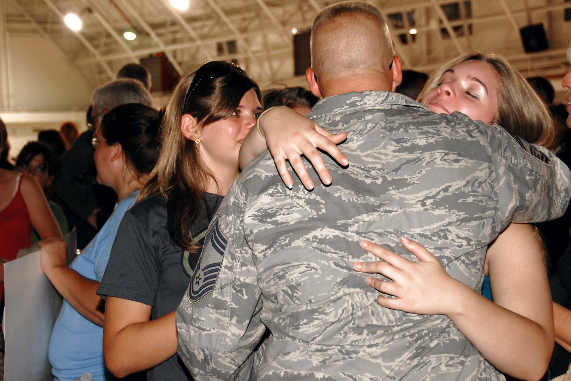 Chief Master Sgt. Mike Will, with the 174th Fighter Wing at Hancock Field, N.Y., greets his family after returning home Aug. 5 from a deployment to Southwest Asia in support of Operation Iraqi Freedom.  (U.S. Air Force photo/Tech. Sgt. Jeremy M. Call) 
