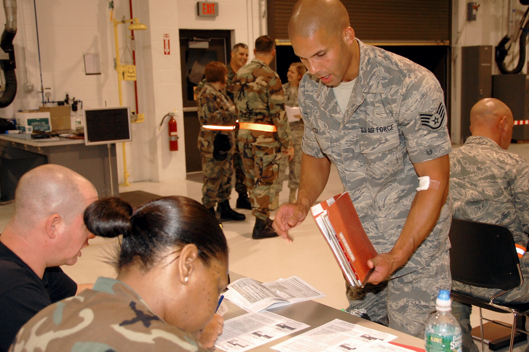 Staff Sgt. Preston Cox, with the 174th Fighter Wing at Hancock Field, N.Y., works his way through the processing line after returning from a deployment to Southwest Asia in support of Operation Iraqi Freedom.  (U.S. Air Force photo/Tech. Sgt. Jeremy M. Call) 