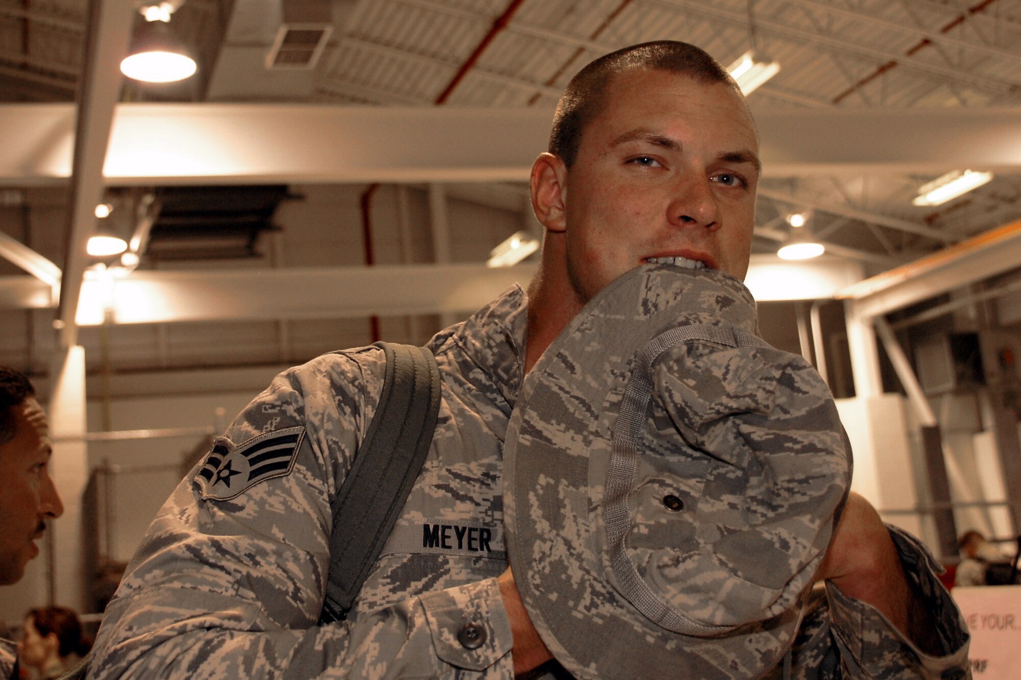 Senior Airman Tyler Meyer, with the 174th Fighter Wing at Hancock Field, N.Y., has his hands full as he stands in the processing line after returning home Aug. 5 from a deployment to Southwest Asia in support of Operation Iraqi Freedom.  (U.S. Air Force photo/Tech. Sgt. Jeremy M. Call) 