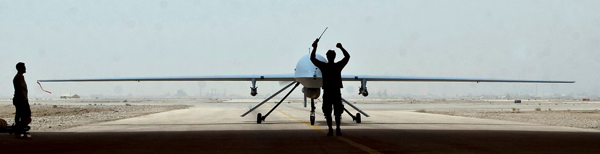 ALI BASE, Iraq -- An MQ-1B Predator remotely piloted aircraft taxies into a hangar here after a mission Aug. 1. A $1 headset modification made by Staff Sgt. Ray Stetler, NCO in charge of base information and infrastructure for the 407th Expeditionary Communications Squadron at Ali Base, Iraq, allows Predator UAS pilots to use voice over secure internet protocol communications through their headsets. Sergeant Stetler is deployed from Tinker Air Force Base, Okla. (U.S. Air Force photo/Airman 1st Class Christopher Griffin)