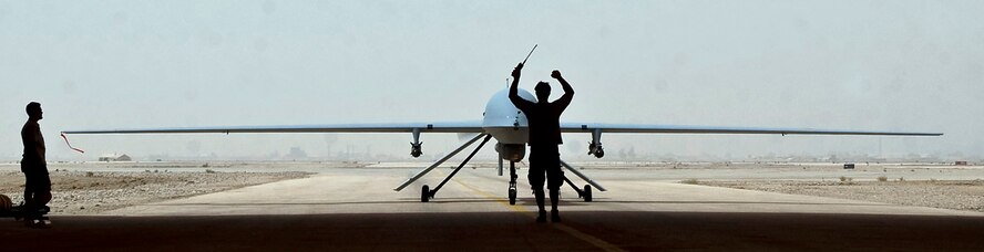 ALI BASE, Iraq -- An MQ-1B Predator remotely piloted aircraft taxies into a hangar here after a mission Aug. 1. A $1 headset modification made by Staff Sgt. Ray Stetler, NCO in charge of base information and infrastructure for the 407th Expeditionary Communications Squadron at Ali Base, Iraq, allows Predator UAS pilots to use voice over secure internet protocol communications through their headsets. Sergeant Stetler is deployed from Tinker Air Force Base, Okla. (U.S. Air Force photo/Airman 1st Class Christopher Griffin)