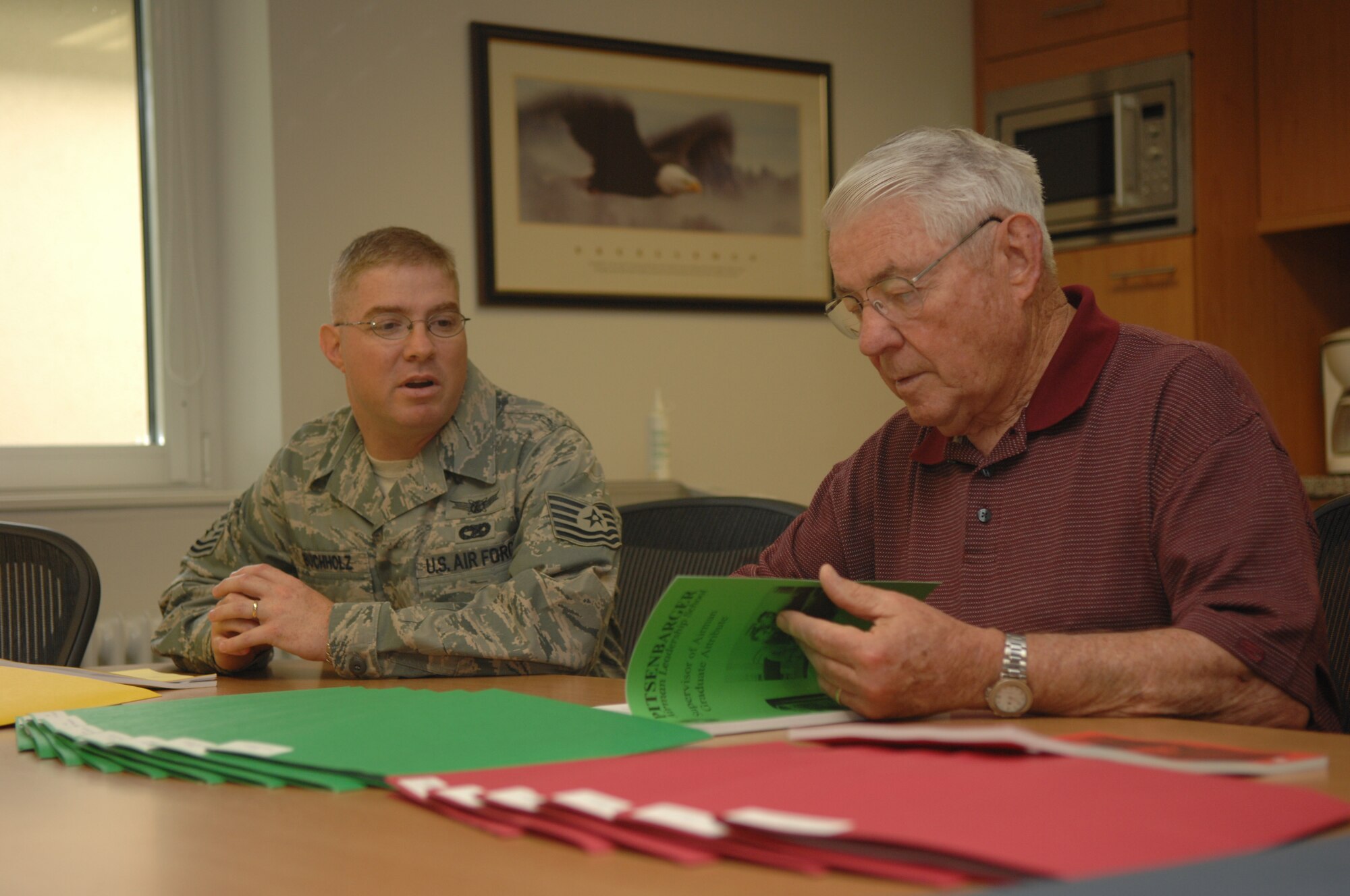 Robert D. Gaylor, 5th Chief Master Sgt. of the Air Force, goes over Airman Leadership School packets with Tech. Sgt.  James Buchholz, 52nd Force Support Squadron, Aug. 4, 2008. Spangdahlem is the 20th base Chief Gaylor visited this year. (U.S. Air Force photo by Airman Staci Miller)