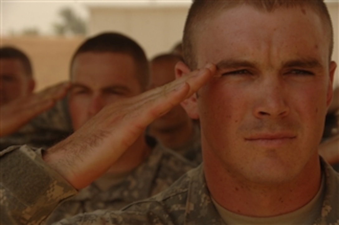 U.S. Army 1st Lt. Ottmar salutes the flag during a ceremony dedicated to the handing over of an Iraqi government house back to local officials in Mahmudiyah, Iraq, on Aug. 5, 2008.  Ottmar is assigned to 1st Squadron, 33rd Cavalry Regiment, 101st Airborne Division.  