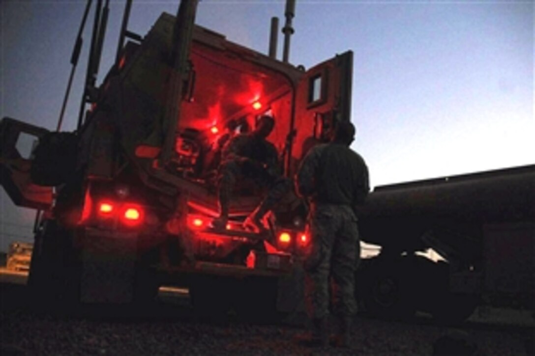 U.S. soldiers prepare for a night convoy where they will depart Camp Taji in Iraq to deliver supplies to various combat outposts, patrol bases and joint security stations, Aug. 5, 2008. The soldiers are assigned to the 1st Battalion, 6th Infantry Regiment Support Platoon. 
                        
