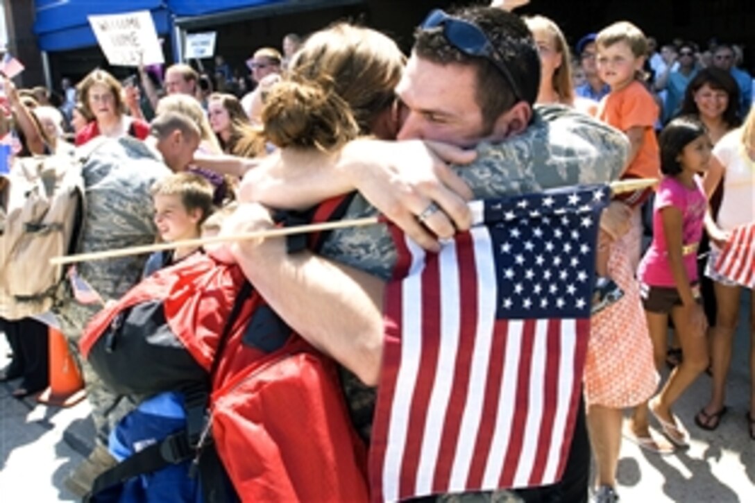U.S. Air Force Airman 1st Class Melissa Krenning, left, an engine maintainer from the Idaho Air National Guard’s 124th Wing, embraces her brother, Airman 1st Class Wesley Krenning, as she returns to Gowen Field in Boise, Idaho, Aug. 7, 2008, following a deployment to Afghanistan. 