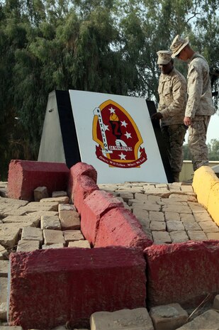 CAMP HABBANIYAH, Iraq (August 10, 2008) – Gunnery Sgt. Desmond Wyatt, the camp commandant for Camp Habbaniyah (left) and Lance Cpl. Thomas Daily, the police sergeant with Headquarters and Service Company, Task Force 1st Battalion, 2nd Marine Regiment, Regimental Combat Team 1, finish displaying the battalion logo in the center of camp. The battalion officially took control of the area from 2nd Battalion, 24th Marine Regiment, Aug. 10. (Official U.S. Marine Corps photo by Lance Cpl. Scott Schmidt)