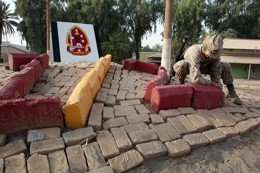 CAMP HABBANIYAH, Iraq (August 10, 2008) – Lance Cpl. Thomas Daily, the police sergeant with Headquarters and Service Company, Task Force 1st Battalion, 2nd Marine Regiment, Regimental Combat Team 1, completes the 1st Bn, 2nd Marines display in the center of camp. The battalion officially took control of the area from 2nd Battalion, 24th Marine Regiment, Aug. 10. (Official U.S. Marine Corps photo by Lance Cpl. Scott Schmidt)