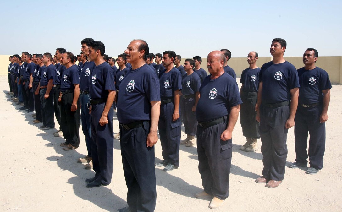 Sons of Iraq who have completed the training program in preparation to become Iraqi Police wear the official t-shirt for the first time in a graduation ceremony on August 12, 2008.