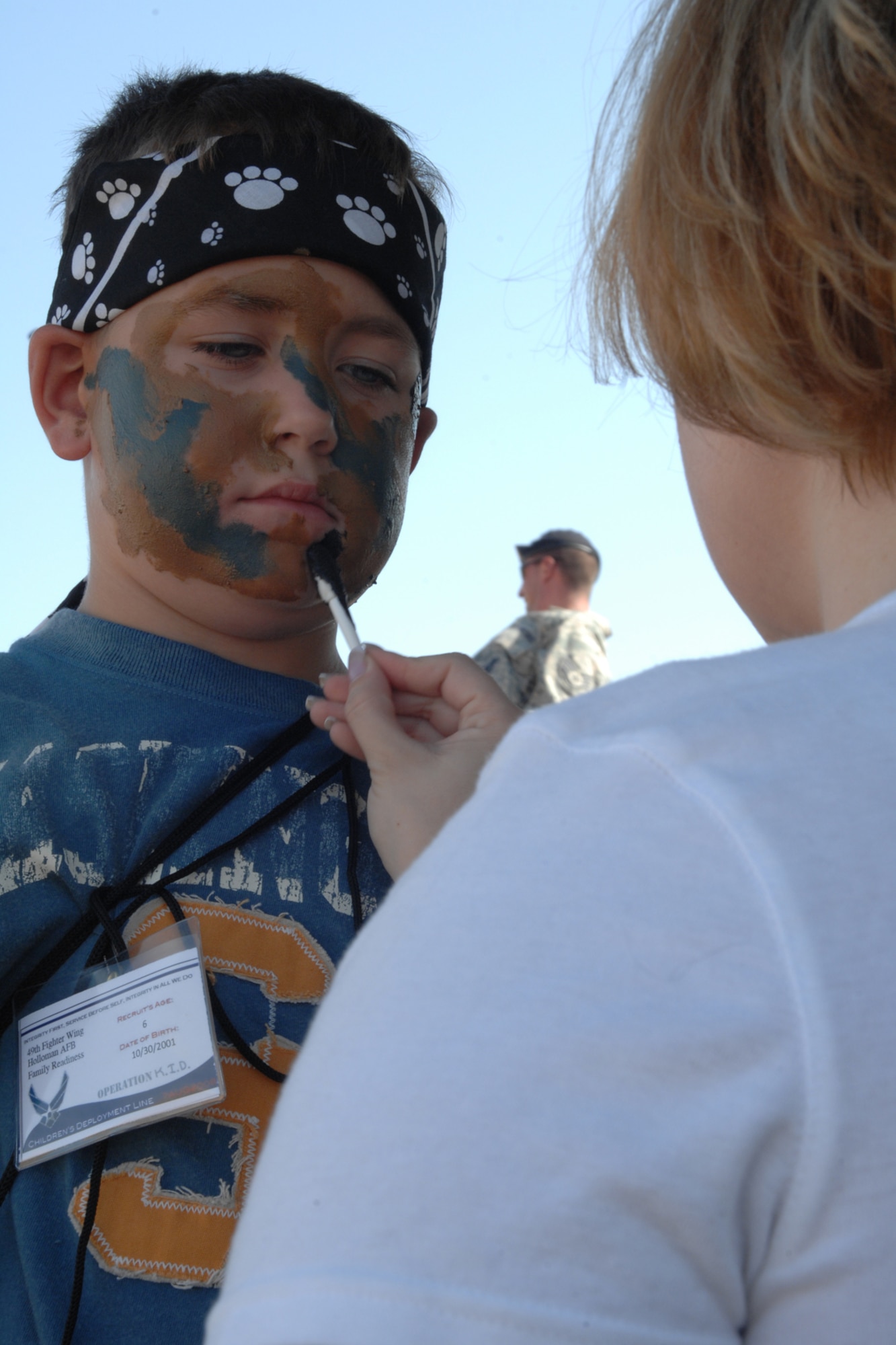 Richard Cusack, 6, receives a face painting at the 49th Security Forces Squadron educational station during the Operation K.I.D. mock deployement to Balad Air Base, Iraq, Aug. 7 at Holloman Air Force Base, N.M. The 49 SFS educational station also had vehicle and weapon displays available. (U.S. Air Force photo/Airman 1st Class Jamal D. Sutter)