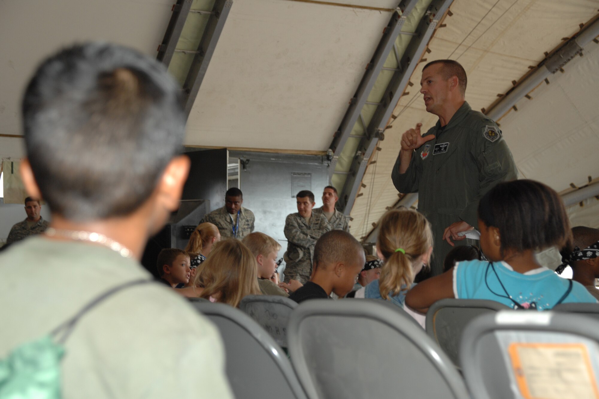 Col. Michael McGee, 49th Fighter Wing vice commander, briefs and answers children's questions during the Operation K.I.D. mock deployement to Balad Air Base, Iraq, Aug. 7 at Holloman Air Force Base, N.M. During the brief, Colonel McGee answered to questions such as, "Why is the F-22A Raptor so cool?" and, "Will we see tanks?" (U.S. Air Force photo/Airman 1st Class Jamal D. Sutter)