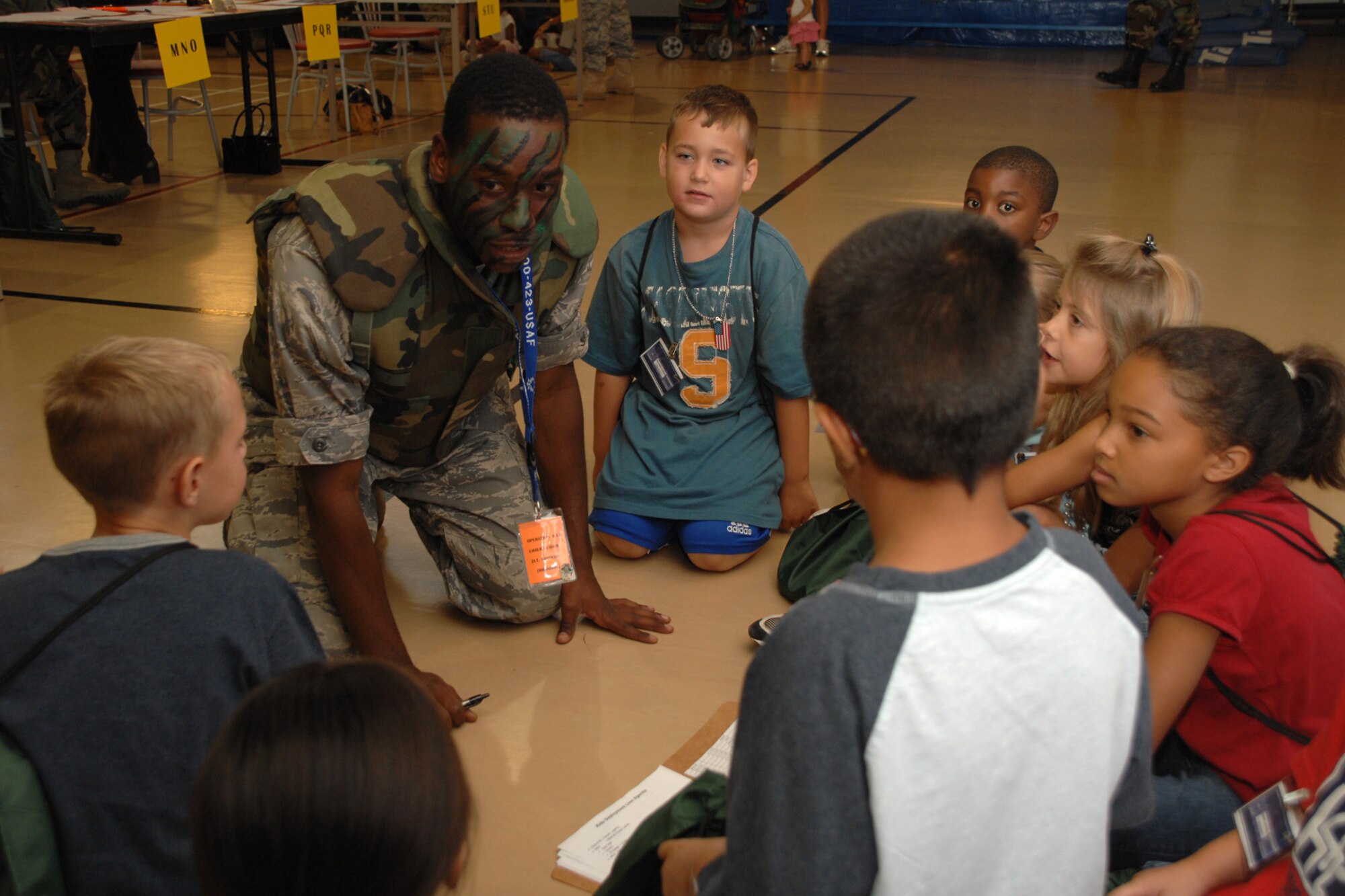 2nd Lt. Brandon Sanders, 49th Civil Engineer Squadron, motivates his chalk during the Operation K.I.D. recall Aug. 7 at Holloman Air Force Base, N.M. During the recall, the children received mock orders, dog tags and identification badges. (U.S. Air Force photo/Airman 1st Class Jamal D. Sutter)