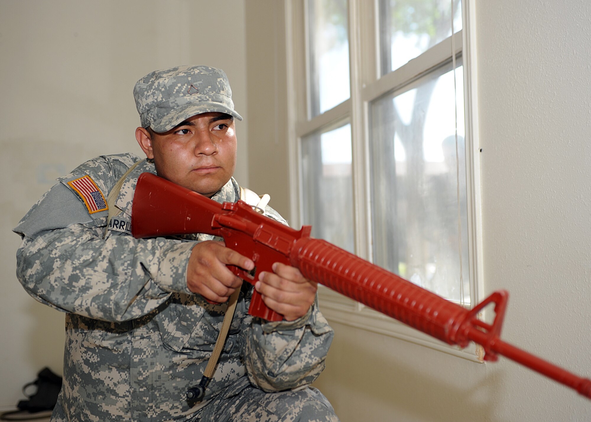 The Army National Guard, based out of Roswell and Alamogordo, N.M., post a guard in an open doorway while clearing a building in the old base housing at Holloman Air Force Base, N.M. The unit is preparing for upcoming live fire training and a pending deployment. (U.S Air Force photo/ Airman 1st Class DeAndre Curtiss) 
