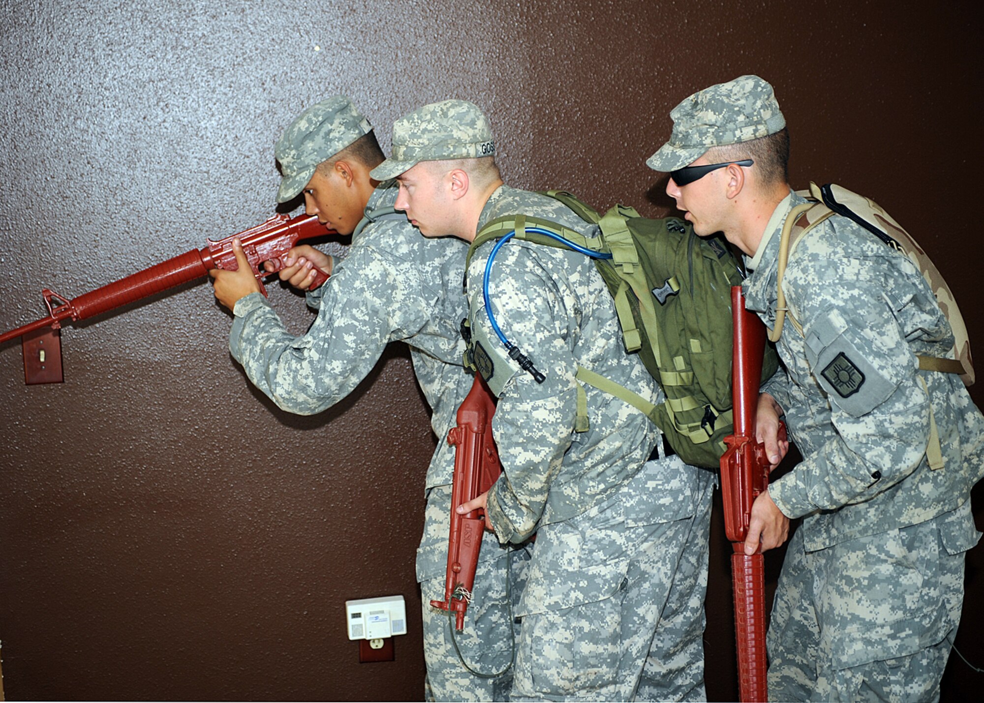 The Army National Guard, based out of Roswell and Alamogordo, N.M., bunches up to be better prepared for a enemy attack when entering a room of an old base housing unit at Holloman Air Force Base, N.M. The unit is preparing for upcoming live fire training and a pending deployment. (U.S Air Force photo/ Airman 1st Class DeAndre Curtiss) 