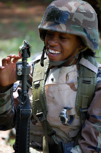 A student in the Advanced Contingency Skills Training Course checks the blank firing adapter on her M-16 rifles during a break in patrolling and tactics training for the course Aug. 12, 2008, on a range on Fort Dix, N.J.  The course, taught by the U.S. Air Force Expeditionary Center's 421st Combat Training Squadron, prepares Airmen from multiple career fields for upcoming deployments.  (U.S. Air Force Photo/Tech. Sgt. Scott T. Sturkol)