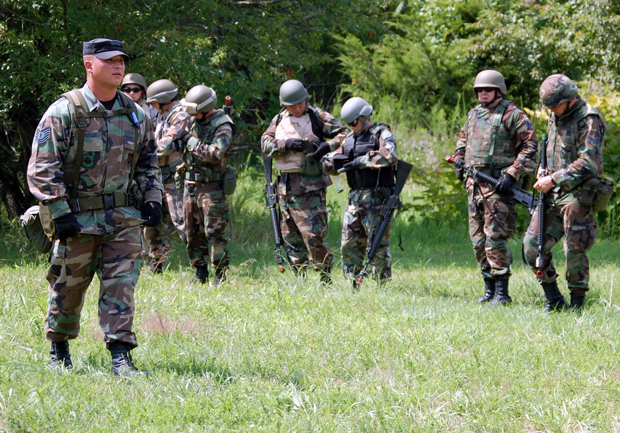 Tech. Sgt. Vincent Schyler, 421st Combat Training Squadron, watches students in the Advanced Contingency Skills Training Course as he directs them in patrolling and tactics training for the course Aug. 12, 2008, on a range on Fort Dix, N.J.  The course, taught by the U.S. Air Force Expeditionary Center's 421st Combat Training Squadron, prepares Airmen from multiple career fields for upcoming deployments.  (U.S. Air Force Photo/Tech. Sgt. Scott T. Sturkol)
