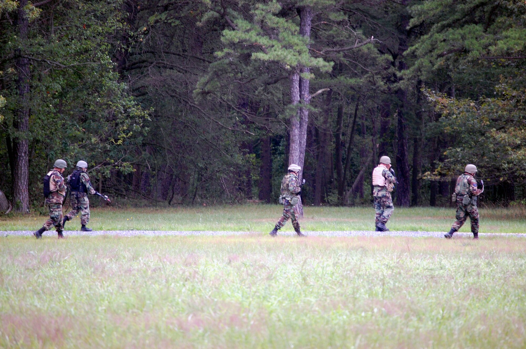 Students in the Advanced Contingency Skills Training Course march in a file formation during patrolling and tactics training for the course Aug. 12, 2008, on a range on Fort Dix, N.J.  The course, taught by the U.S. Air Force Expeditionary Center's 421st Combat Training Squadron, prepares Airmen from multiple career fields for upcoming deployments.  (U.S. Air Force Photo/Tech. Sgt. Scott T. Sturkol)