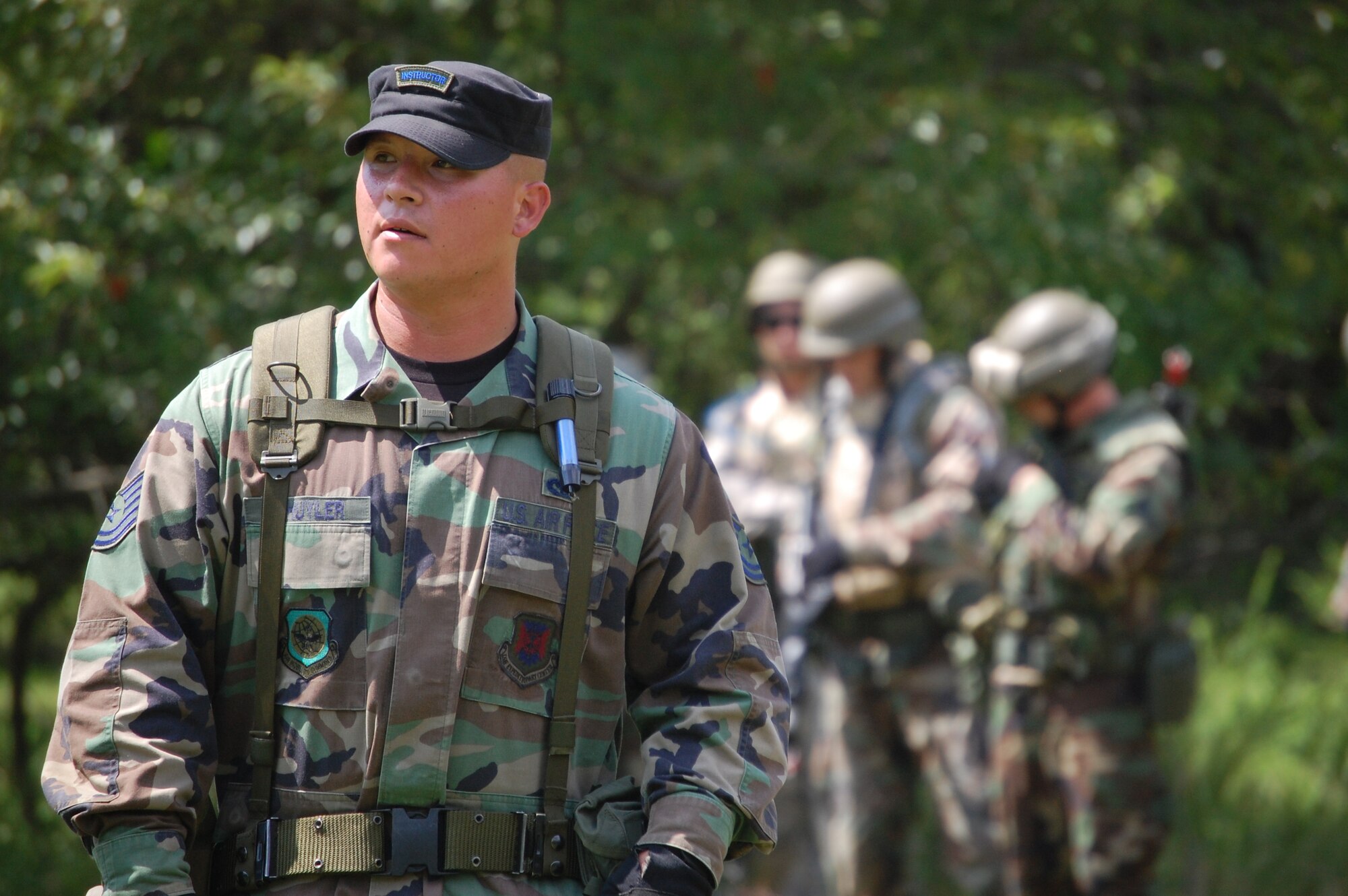 Tech. Sgt. Vincent Schyler, 421st Combat Training Squadron, watches students in the Advanced Contingency Skills Training Course as he directs them in patrolling and tactics training for the course Aug. 12, 2008, on a range on Fort Dix, N.J.  The course, taught by the U.S. Air Force Expeditionary Center's 421st Combat Training Squadron, prepares Airmen from multiple career fields for upcoming deployments.  (U.S. Air Force Photo/Tech. Sgt. Scott T. Sturkol)