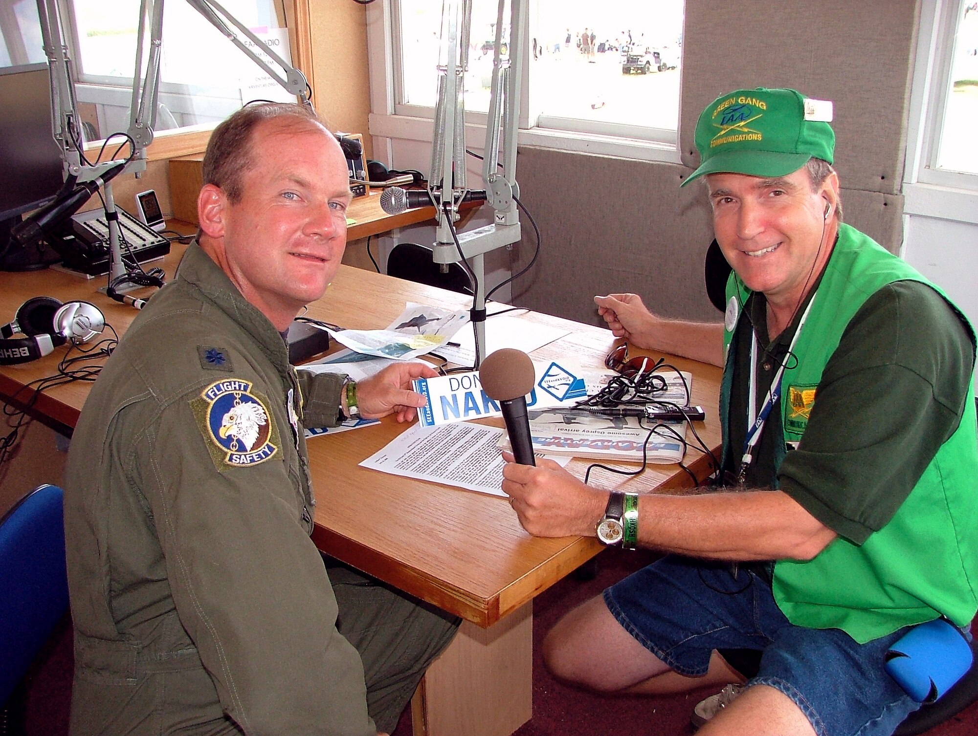 Rob Sturgeon, a radio broadcaster with the Experimental Aircraft Association, interviews Lt. Col. Ned Linch, the 12th Air Force (Air Forces Southern) chief of flight safety, during the EEA's Oshkosh Air Venture airshow.  More than 540,000 civilians and military pilots from around the globe gathered in Oshkosh, Wis., July 31 through Aug. 3 for the event. The colonel was attending the airshow to educate general aviation and civilian pilots on midair collision avoidance and on the need for flight safety and planning awareness.  (U.S. Air Force photo/Tech. Sgt. Kerry Jackson)