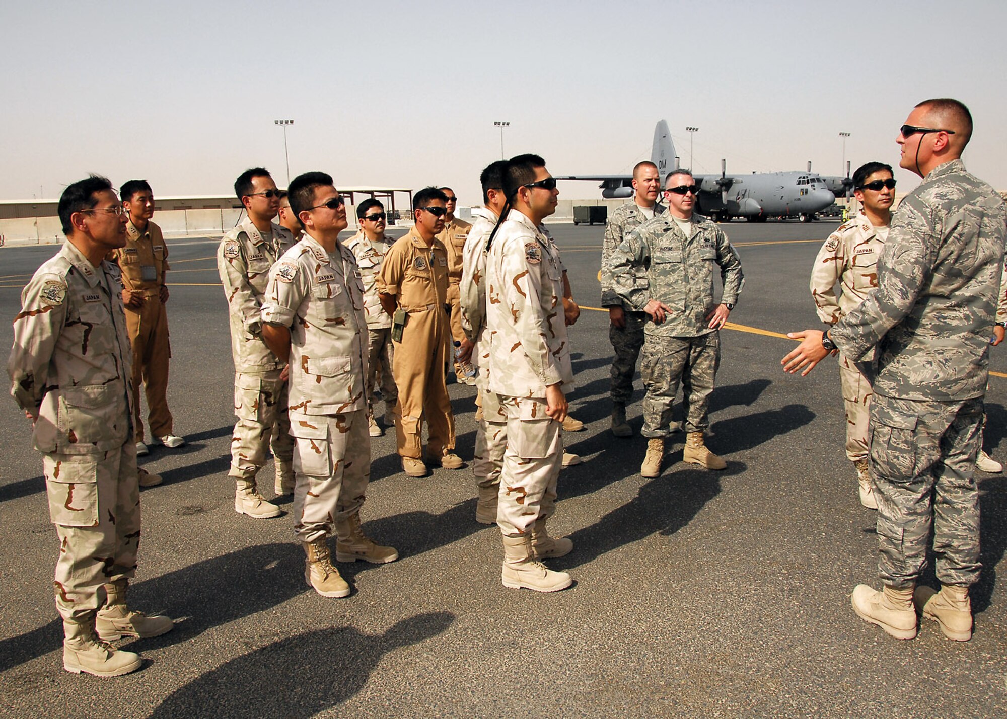 1st Lt. David Marques briefs Japan Air Self-Defense Force members on the capabilities of a EC-130H Compass Call at a base in Southwest Asia. The brief was part a coalition maintenance exchange program between the U.S. Air Force, JASDF and the Republic of Korea air force, which promotes an exchange of aircraft maintenance ideas and practices between them. Lieutenant Marques is the 386th Silver Aircraft Maintenance Unit officer in charge. (U.S. Air Force photo/Tech. Sgt. Raheem Moore)