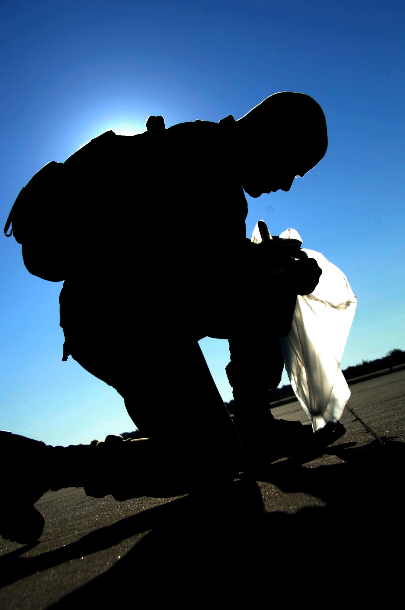Airman 1st Class Daniel Jones performs a foreign object debris walk on the flightline Aug. 6 at a simulated air base in East Asia during the operational readiness inspection. A picnic to celebrate a job well done for the ORI will take place in the Charleston Club at 1:30 p.m. Airman Jones is with the 437th Aircraft Maintenance Squadron. (U.S. Air Force photo/Airman 1st Class Timothy Taylor)