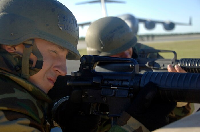 Senior Airmen Robert Venable and James Patton guard the flightline at a defensive fighting position Aug. 8 on a simulated air base in East Asia during the operational readiness inspection. Air Mobility Command inspectors will brief the results of the inspection in the base theater Aug. 15 to the 437th Airlift Wing at 10 a.m. and the 315th Airlift Wing at 11 a.m.  Airmen Venable and Patton are with the 437th Aircraft Maintenance Squadron. (U. S. Air Force photo/Airman 1st Class Timothy Taylor)