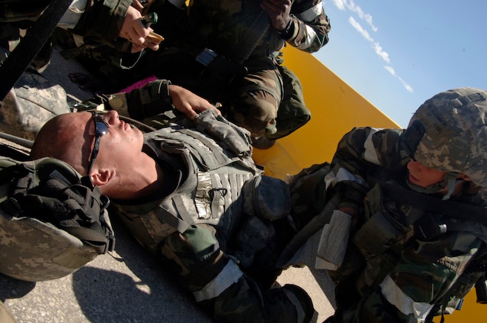 Airman 1st Class Christine Aylesworth provides first-aid for Airman Basic Ryan Dodson after a vehicle-borne improvised explosive device detonation exercise Aug. 8 at a simulated air base in East Asia during the operational readiness inspection.  During the ORI, Airmen were evaluated on their immediate capabilities to provide self-aid and buddy care to prevent loss of life. Airmen Aylesworth and Dodson are with the 437th Security Forces Squadron. (U.S. Air Force photo/Airman 1st Class Timothy Taylor)