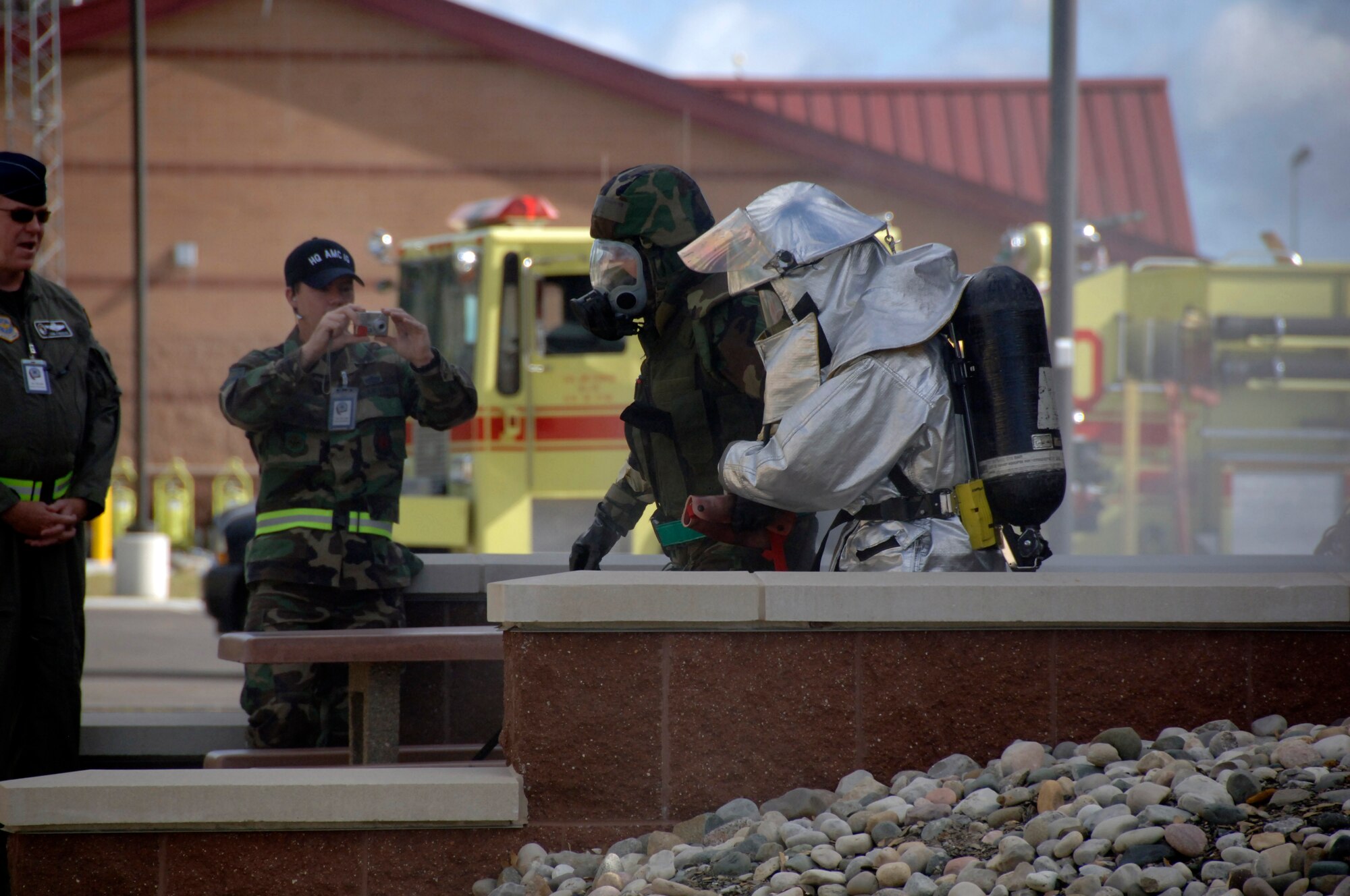 Lt. Col. Gregory Williams is escorted from the installation control center by a fireman after a simulated attack on the facility Aug. 8 at a simulated air base in East Asia during the operational readiness inspection. During the scenario, Airmen had to demonstrate knowledge of life-saving skills to treat members injured during the attack. Colonel Williams is the 437th Mission Support Group deputy commander. (U. S. Air Force photo/Airman 1st Class Timothy Taylor)