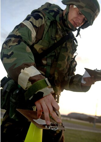 Senior Airman Stephen Russ marks the date and time on M-8 Paper Aug. 7outside the emergency operations center at a simulated air base in East Asia. M-8 Paper needs to have the time and date recorded every time an individual checks for contamination or replaces it.  Airman Russ is with the 437th Aerial Port Squadron. (U.S. Air Force photo/Airman 1st Class Timothy Taylor)
