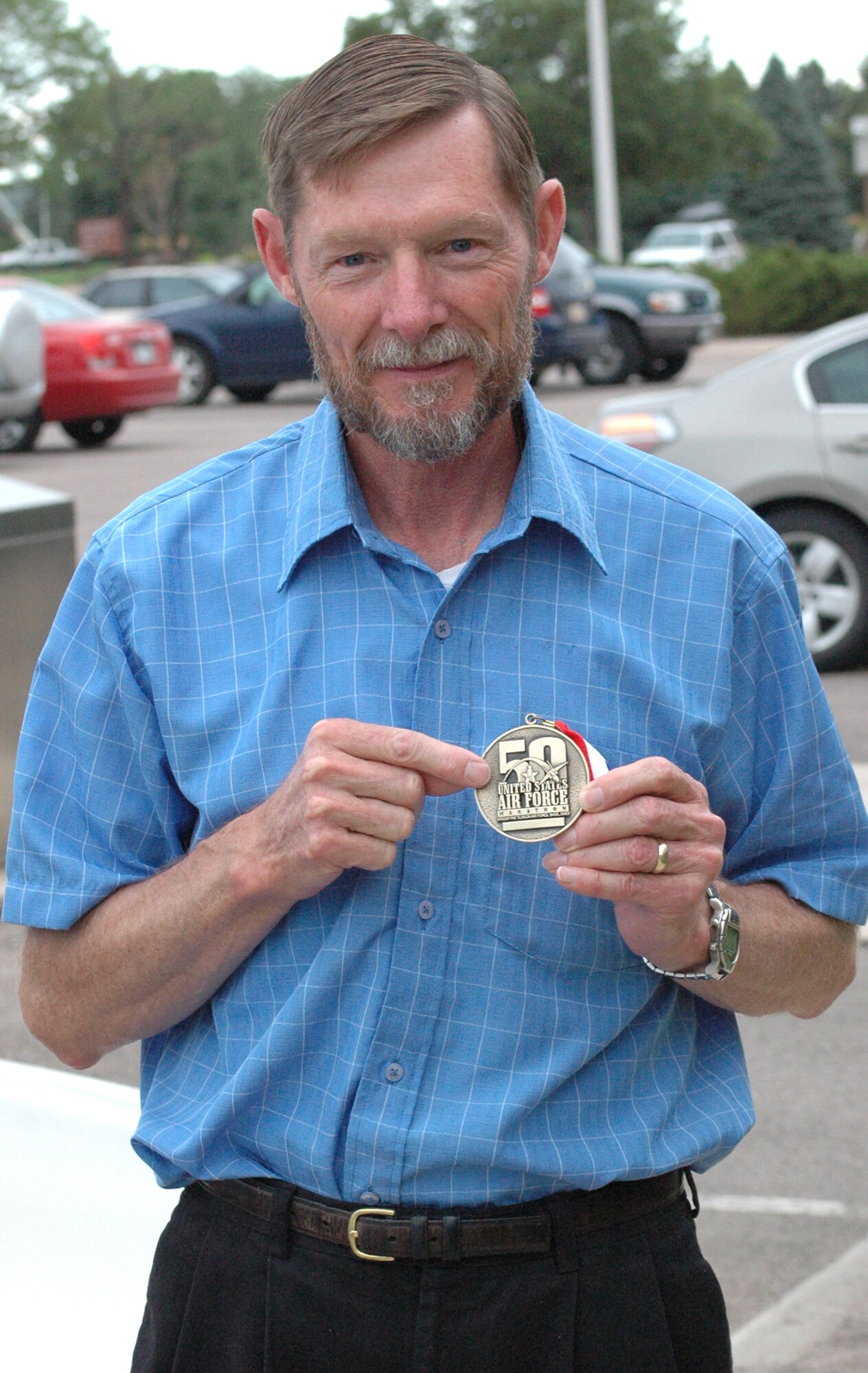 Clyde Landry shows his medallion from his first Air Force Marathon recently at Peterson Air Force Base, Colo. (Courtesy photo)