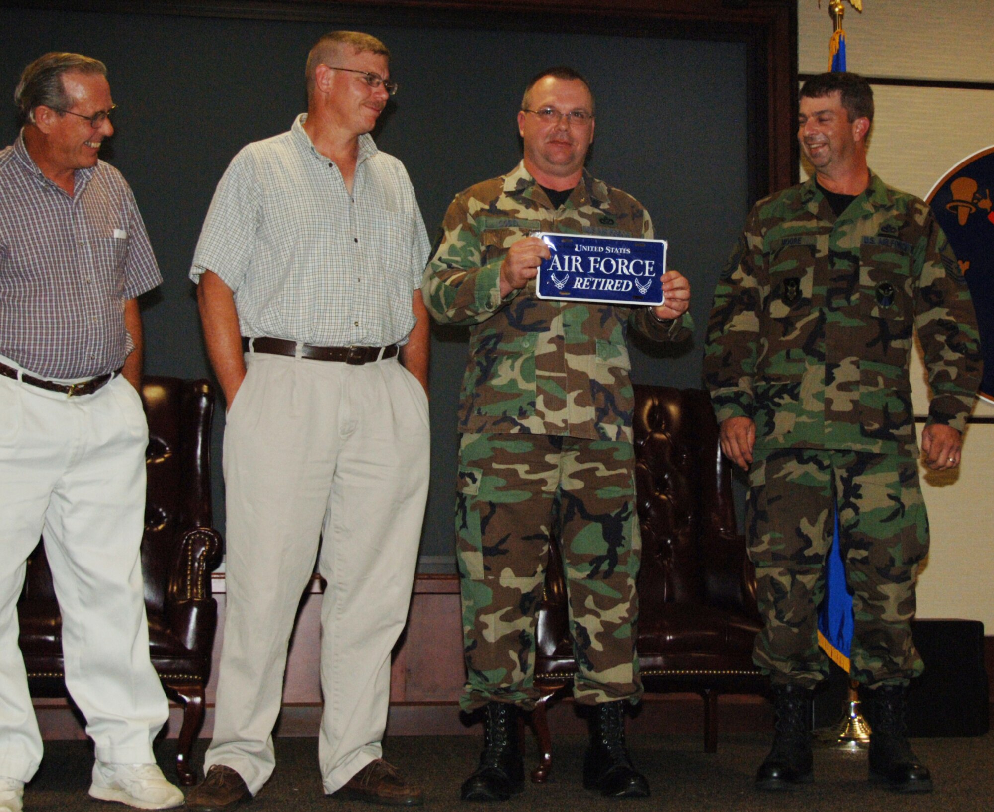 Master Sgt. Shelby Gobel holds up one of the gifts he received from fellow engineers during his retirement ceremony on Aug. 9.  Sergeant Gobel retired from the 931st Civil Engineer Squadron two years after he collided with a deer while riding a motorcycle.