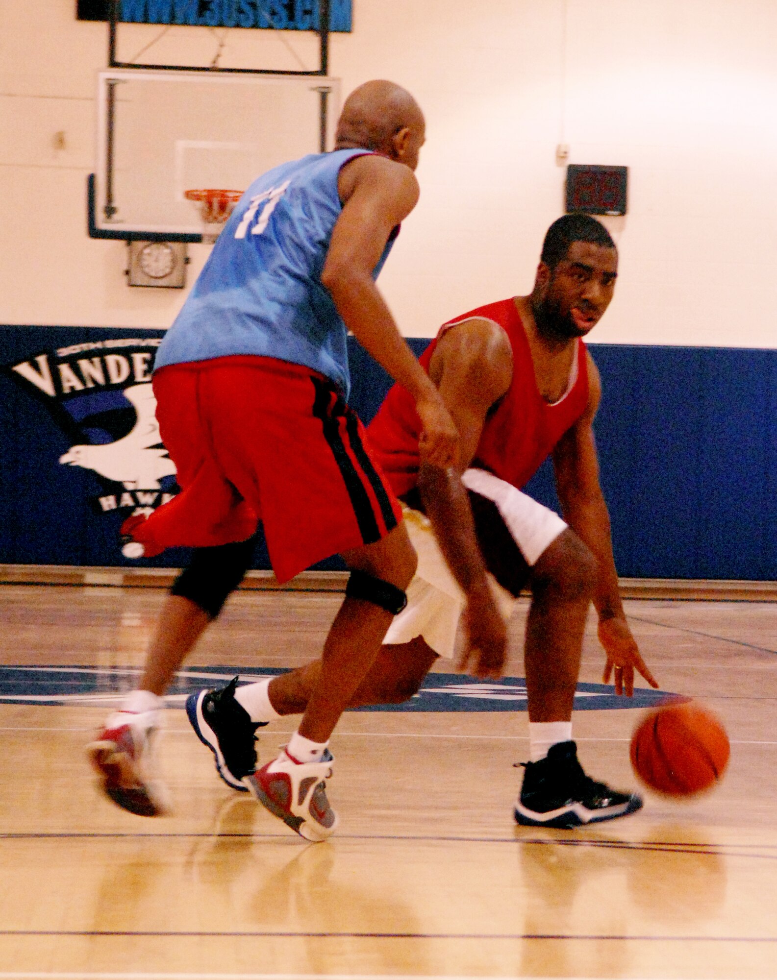 VANDENBERG AIR FORCE BASE, Calif. -- Fred McCree, 30th Medical Operations Squadron, passes by his defender, Marlin Edwards, JFCC Space, during an intramural basketball game at the base gym recently. (U. S. Air Force photo / Airman 1st Class Antoinette Lyons)