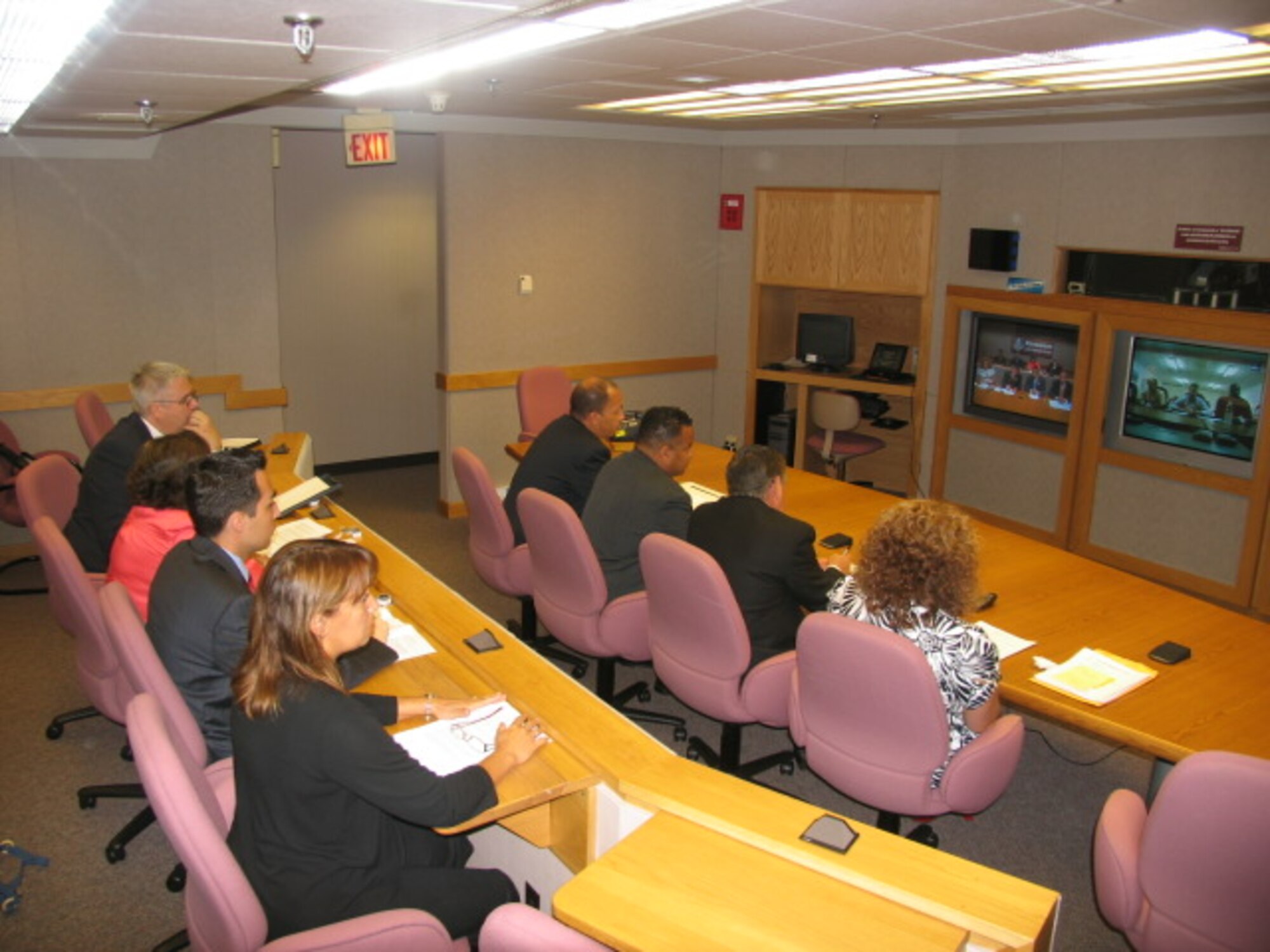 HANSCOM AFB, Mass. – Members of the New Bedford, Mass. City Council hold a mock city council meeting via video teleconference at Hanscom Aug. 10 for approximately 30 city and town officials from various districts in Iraq. The meeting was to demonstrate for the Iraqi officials some of the parliamentary, legislative and executive communication procedures applied by American town governments. (U.S. Air Force photo by James Corcoran)