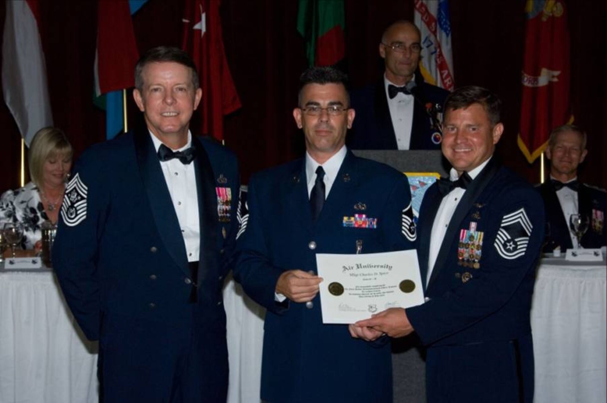MAXWELL-GUNTER AIR FORCE BASE, Ga. --  Master Sgt. Charles Spice, superintendent of operations for the National Reconnaissance Office at Vandenberg, is given the Air Force Senior Noncommissioned Officer Academy’s Distinguished Graduate Award for Class 08D by the Chief Master Sgt. Dennis Norman, commandant of the SNCOA, and Chief Master Sgt. Rodney McKinley, the Chief Master Sergeant of the Air Force. Selection as distinguished graduate is based on his total performance during the class.  Receiving this award is a significant achievement as Sergeant Spice was selected from a class of 312 students from across the Air Force, Army and Coast Guard, including seven international students, representing the “best” of the enlisted corps. (Courtesy photo)