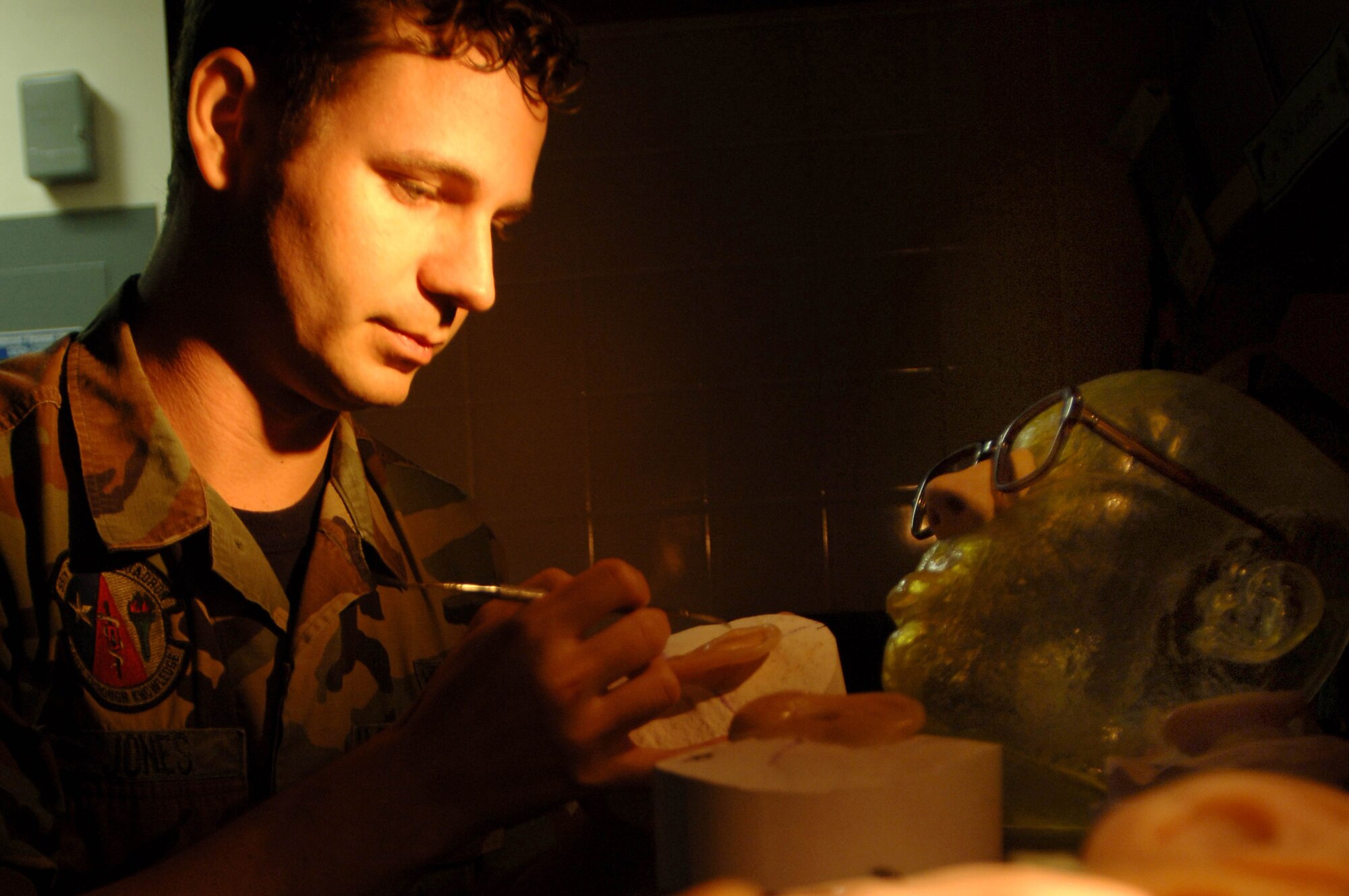 Senior Airman Justin Jones creates a new ear for a patient using a model created by the stereolithography lab at MacKown Dental Clinic at Lackland Air Force Base, Texas. Airman Jones is a maxillofacial prosthetic technician assigned to the 59th Dental Squadron at Lackland AFB. (U.S. Air Force photo/Staff Sgt. Erin Peterson)