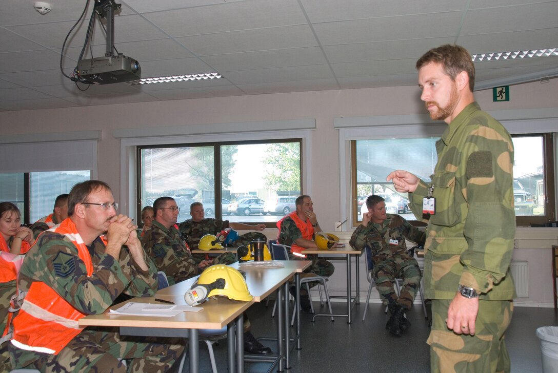 August 11, 2008, Rygge, Air Force Base, Norway- 
1st Lt. Yngve Brathen  a Cadet with the Norwegian Military Academy, briefs members of the Iowa Air National Guard, 185th Air Refueling Wing (ARW), Civil Engineering (CE) in Sioux City, Iowa. CE members deployed for training to Rygge Air Force Base, Norway, in support of Operation Impeccable Glove 2008. The engineering joint training mission is a humanitarian mission with the Norwegian Air force and Army Cadets, from the Norwegian Military Academy.

Official Air Force Photo By: SSgt. Oscar M. Sanchez-Alvarez
