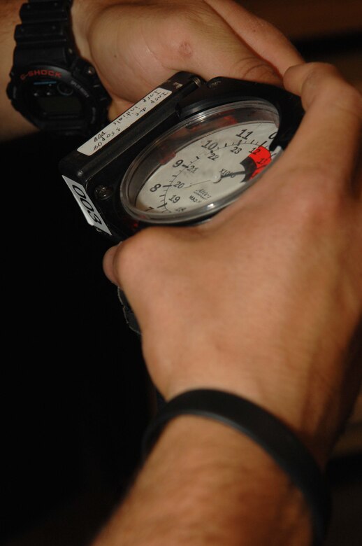 A pararescueman from the 48th Rescue Squadron checks his altimeter prior to jump operations here August 5.  (U.S. Air Force photo by Senior Airman Alesia Goosic)