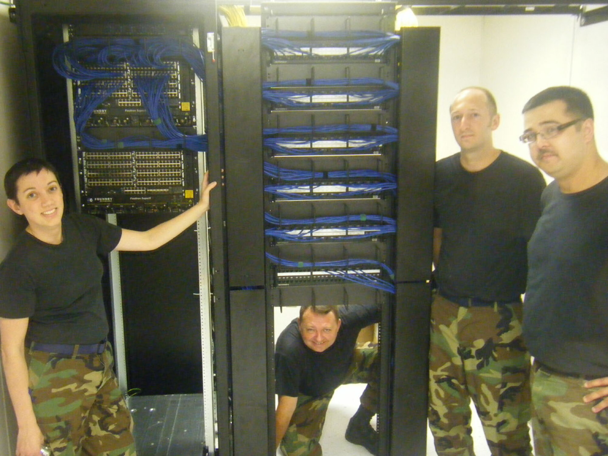 SEYMOUR JOHNSON AIR FORCE BASE, N.C. -- Reservists from the 916th Communications Squadron show the progress of a cable installation project at MacDill Air Force Base, FL. The communicators deployed to the Florida base to assist in the wiring of new buildings. Pictured from left to right are: Senior Airman Kelli Miller, Staff Sgts. Michael Joyner, George Farlow and Shaun Manzano. All are computer systems operators and technical controllers.