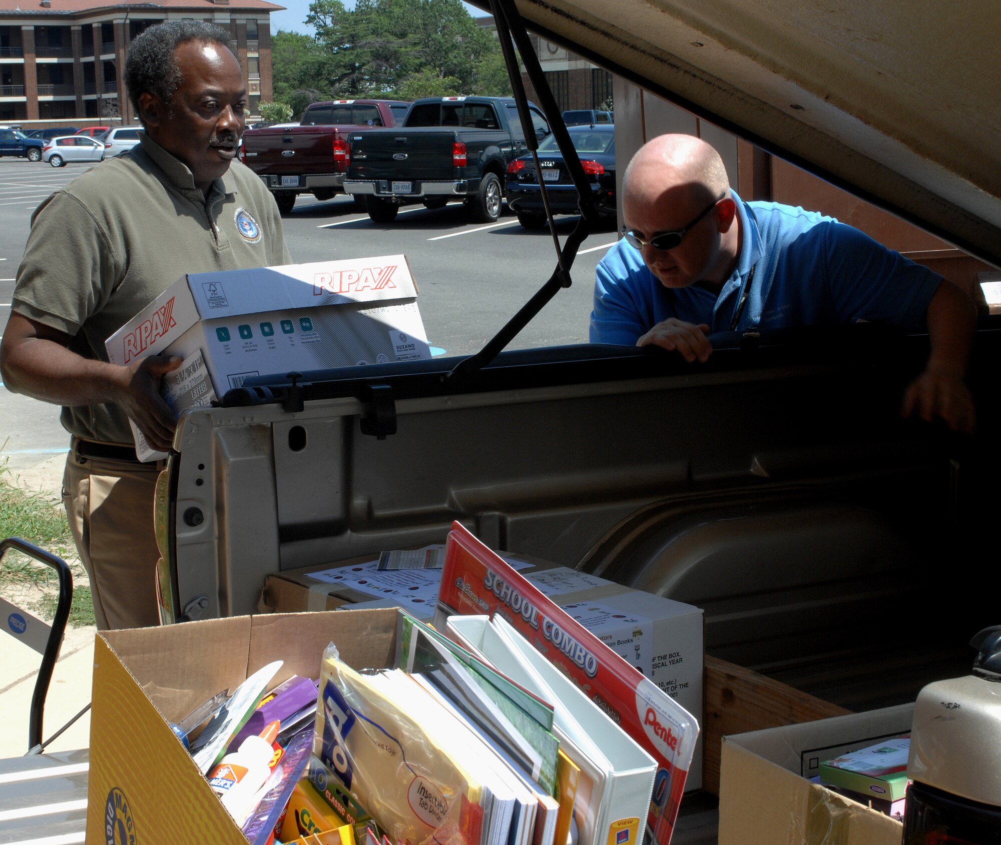 LANGLEY AIR FORCE BASE, Va. – Mr. Edward Lawson, retired Chief Master Sergeant and Mr. Jeff Lokenzen, a local contractor, load school supplies in one of two trucks Aug. 8.  The American Society of Military Comptrollers collected two truck loads and one car full of school supplies for the Salvation Army to distribute to children in Hampton, Newport News, Poquoson and lower York County areas.  Langley agencies along with some Navy and Coast Guard are some of the groups that helped ASMC collect all the school supplies.  (U.S. Air Force photo/Airman 1st Class Zachary Wolf)