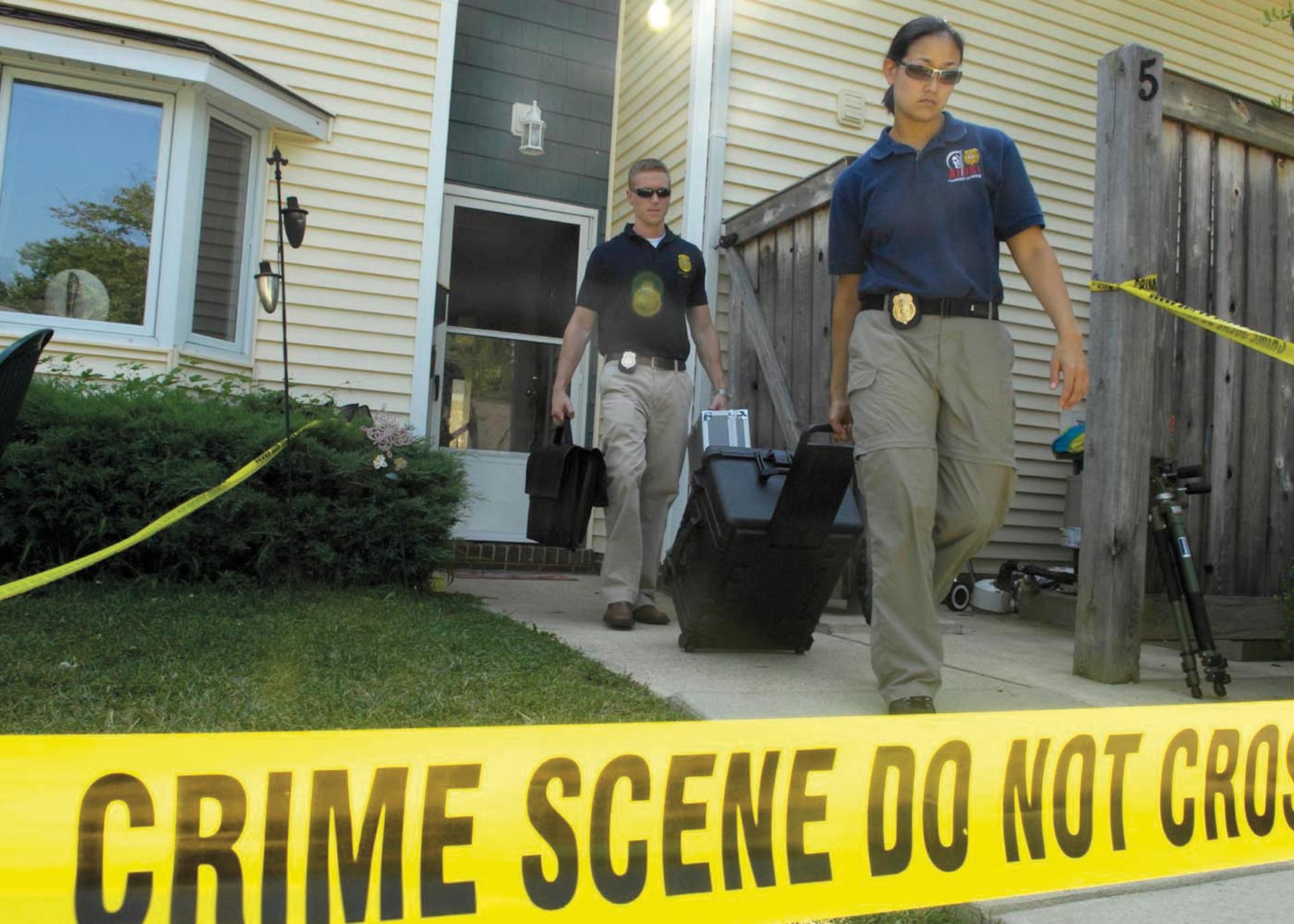 Special Agents Martha Ward and Bryan Schmelzer, Forensic Science Consultants, 2nd Field Investigations Squadron, AFOSI Region 7, depart from a house they used for training July 17. (U.S. Air Force photo/Senior Airman Renae L. Kleckner)