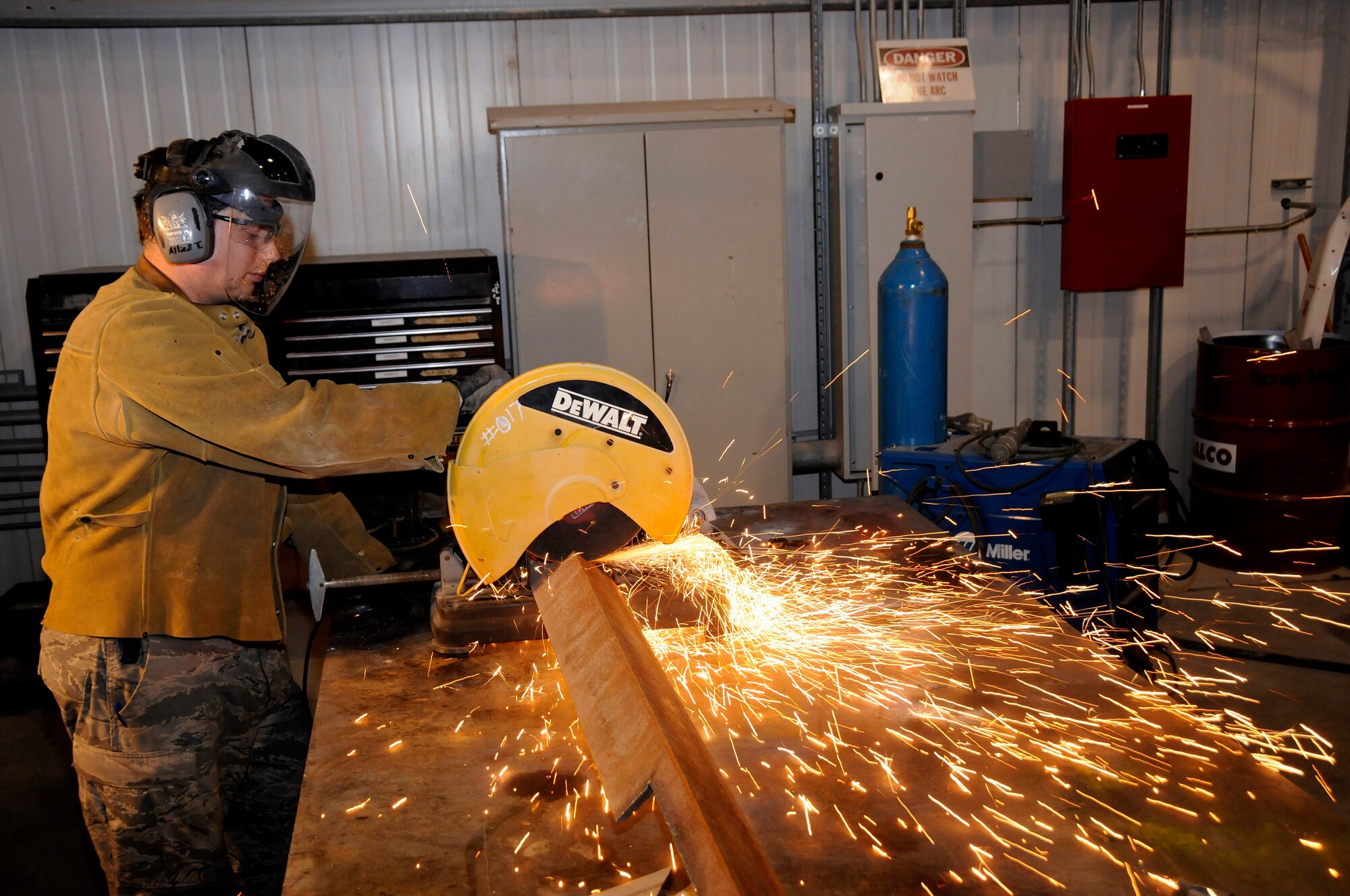 TSgt Pete Nikolakakos, 1st Expeditionary Rapid Engineer Deployable Heavy Operational Repair Squadron Engineers (RED HORSE) Group, unleashes a fountain of sparks while using the chop saw Aug. 11, 2008, at an undisclosed air base in Southwest Asia. Sgt Nikolakakos, a machinist deployed from the 823rd RED HORSE Squadron, Hurlburt Field, Fla., cuts steel L angles used to fabricate a bracket.  The 1st Expeditionary RED HORSE Group performs heavy repair and construction projects throughout the US Central Command’s area of responsibility. Sergeant Nikolakakos, a native of Florence, S.C., is deployed in support of Operations Iraqi Freedom, Enduring Freedom and Joint Task Force-Horn of Africa. (U.S. Air Force photo by Tech. Sgt. Michael Boquette/Released)