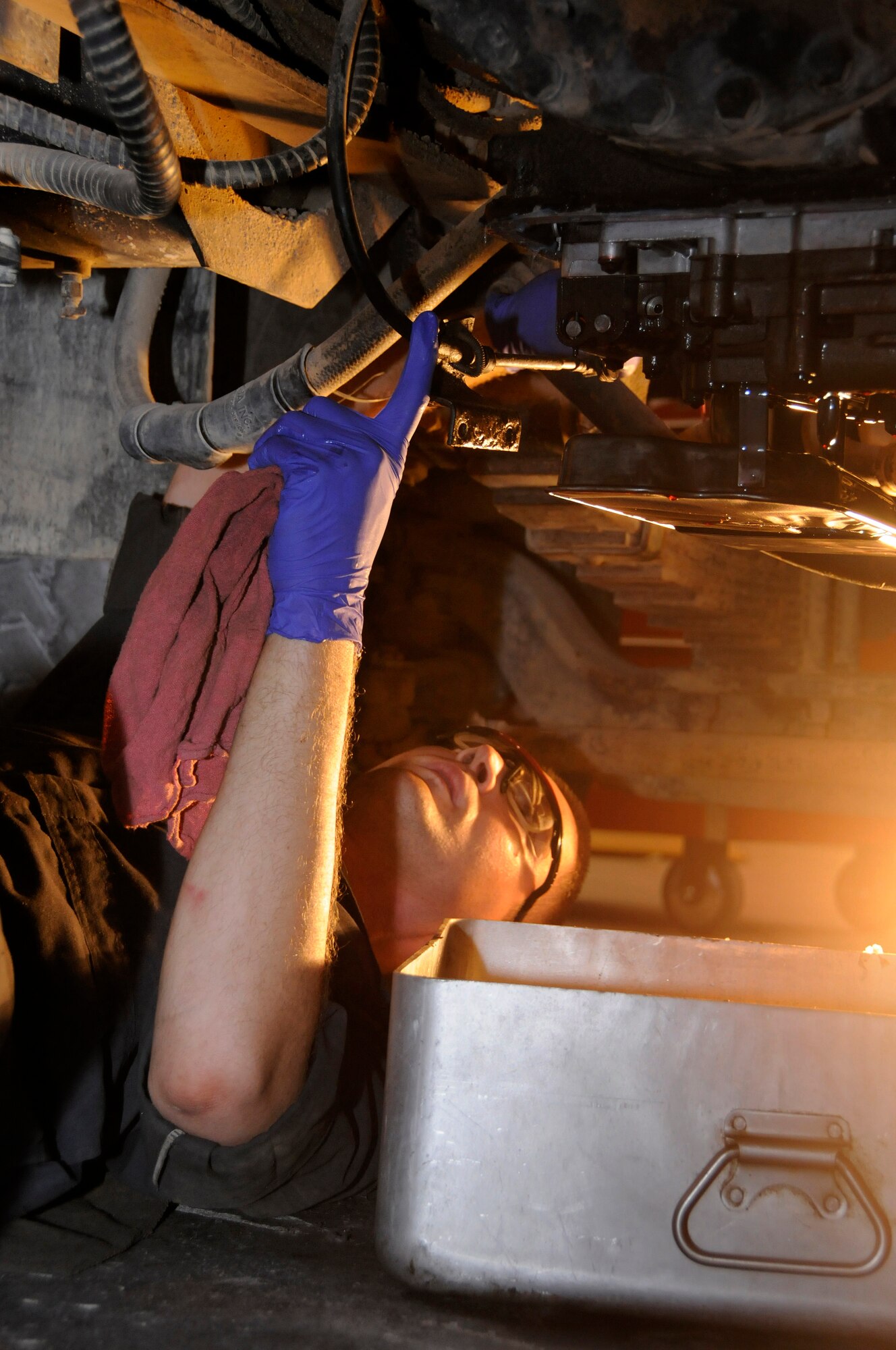 Staff Sgt. Jarret Gordon, 1st Expeditionary Rapid Engineer Deployable Heavy Operational Repair Squadron Engineers (RED HORSE) Group, applies sealant to the oil pan area of a dump truck prior to reattaching the oil pan Aug. 11, 2008, at an undisclosed air base in Southwest Asia. Sergeant Gordon maintains vehicles for the Expeditionary Red Horse Group, which performs heavy repair and construction projects throughout the US Central Command’s area of responsibility. Sergeant Gordon, a native of Magalia, Calif., is deployed from Barksdale Air Force Base, La., in support of Operations Iraqi Freedom, Enduring Freedom and Joint Task Force-Horn of Africa. (U.S. Air Force photo by Tech. Sgt. Michael Boquette/Released)